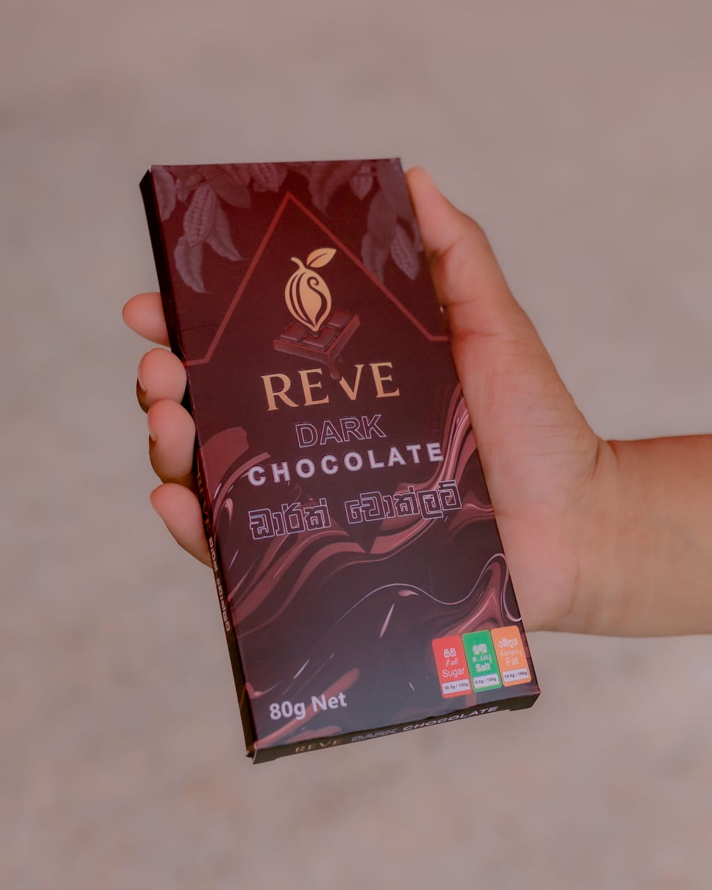Reve dark chocolate bar held in hand
